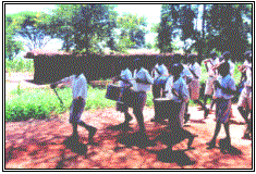 Drummers March Pass a Gogo House