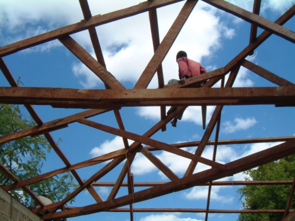 Gilbert Samile Adjusts some Roofing Struts