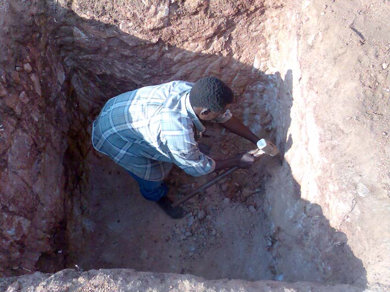 Though friable the limestone rock outcrops needed to be cut out by hand to complete the pad foundation bases - Petro (the swahili version of Peter, meaning rock),undertakes this work!